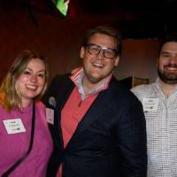 Three alumni hanging out together at the event.